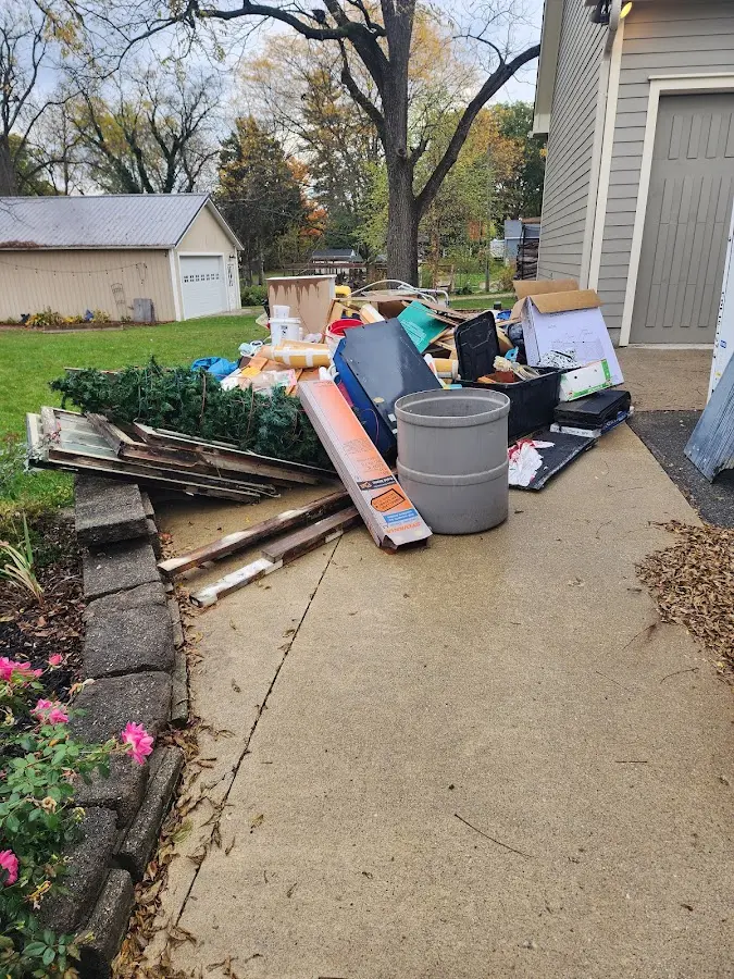 Dumpster being loaded with debris for Roofing Dumpster Rental in East Richmond Heights